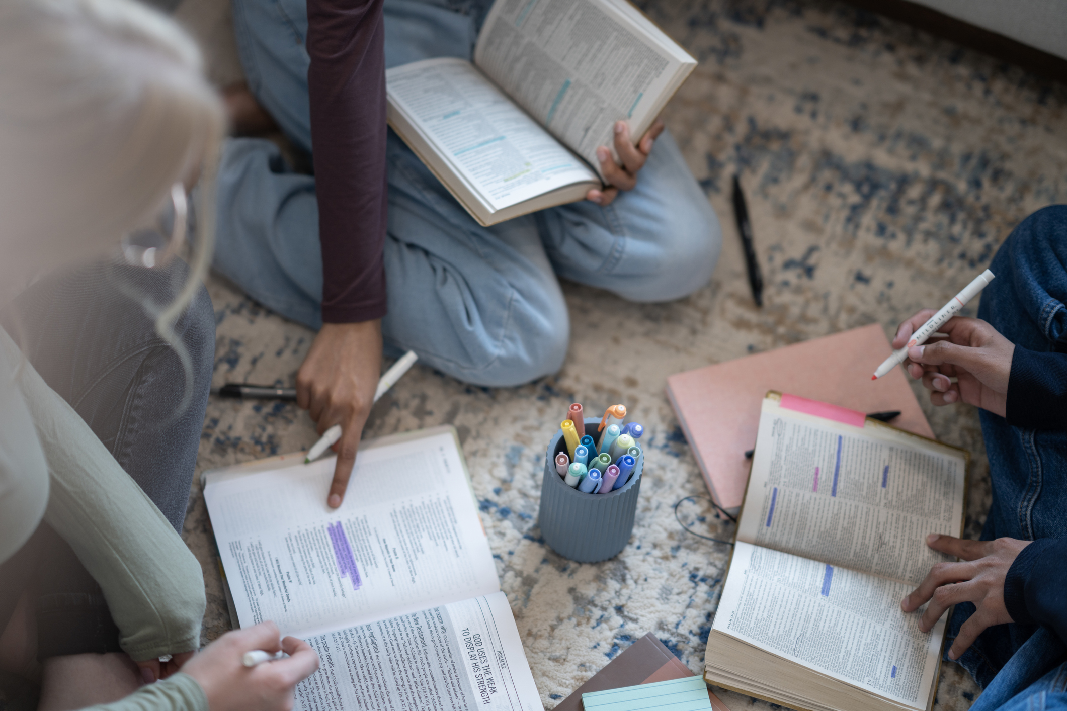 Open Bibles and highlighters in a study group